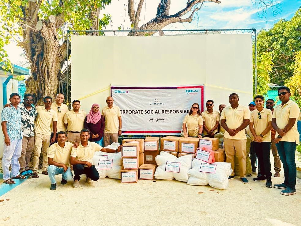 Group portrait of Colours of OBLU team at a CSR event